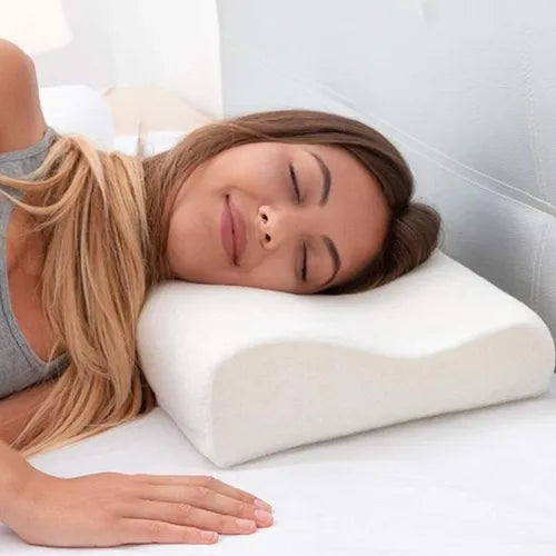 Relaxed woman sleeping on white contoured memory foam pillow that supports her neck and spine perfectly. Ideal for side sleepers and pain-free rest.
