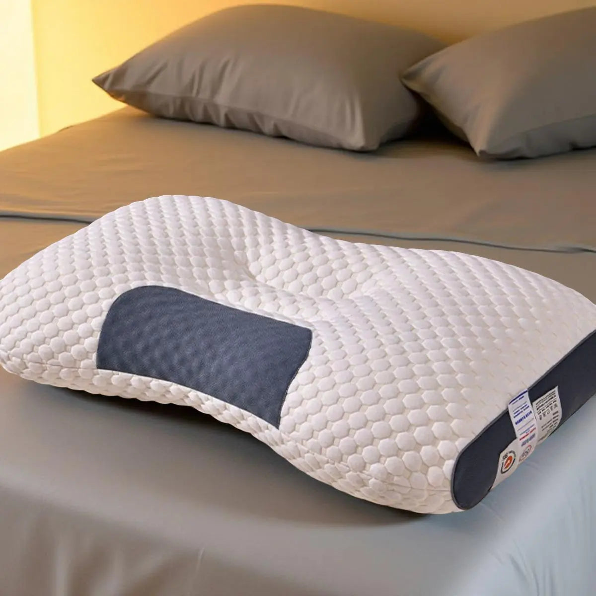 Orthopedic neck pillow on grey bedding – perfect for side sleepers and neck pain relief
