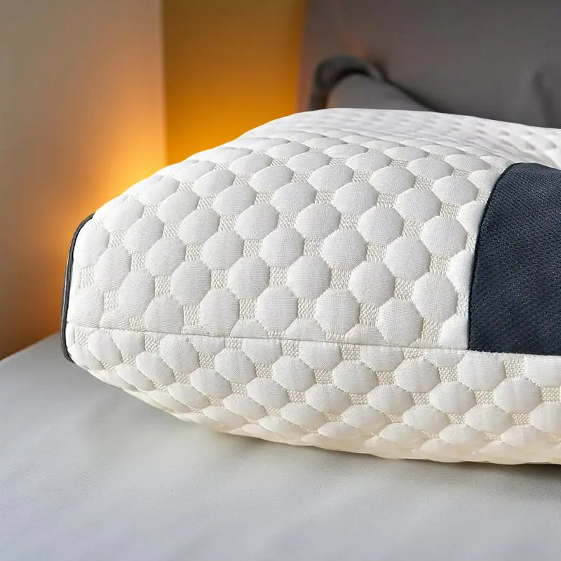 Close-up of white quilted orthopedic neck pillow with contoured design for optimal support