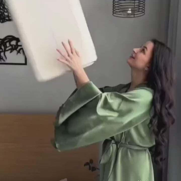 Close-up of hand pressing into white memory foam pillow core to show its softness and contouring effect. Demonstrates high-quality material for neck and spine support.